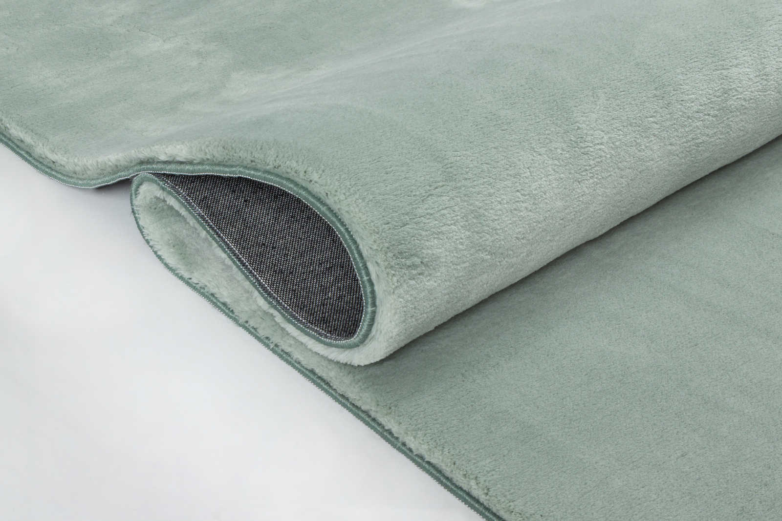             Soft high pile carpet in soft green - 150 x 80 cm
        